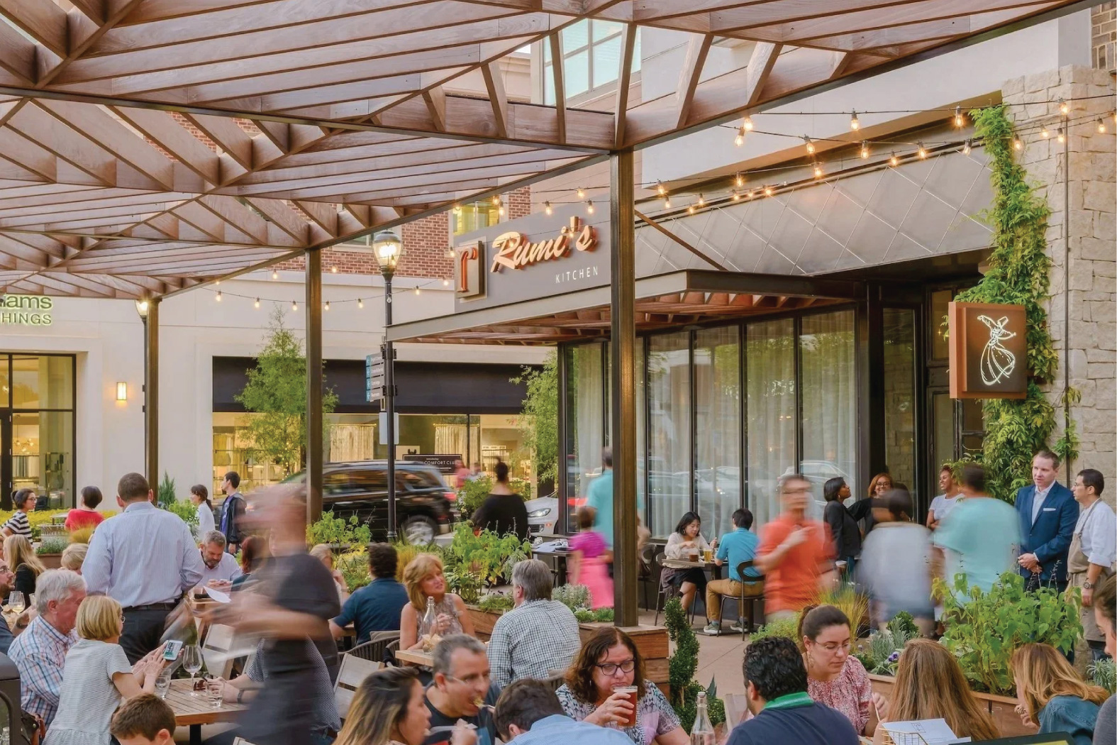 Diners on the busy patio at Rumi's Kitchen at Avalon