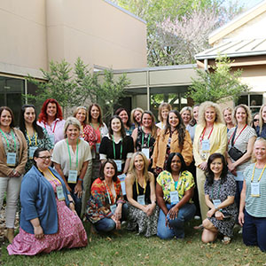 Large group of women members posing together outdoors