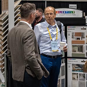 Members in conversation at a supplier booth in the exhibit hall
