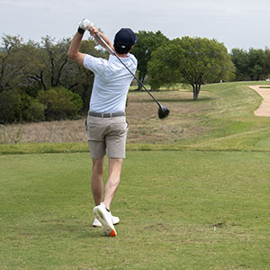 Golfer teeing off at the golf tournament