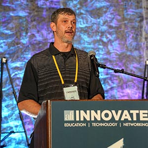 Member speaking at the INNOVATE podium