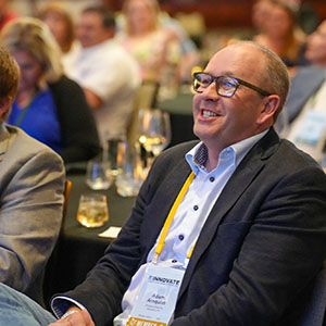Smiling member in the audience at a past convention
