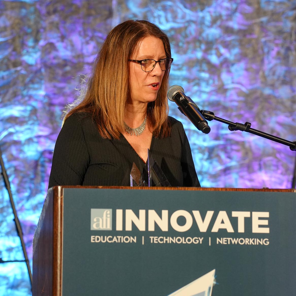 Award recipient speaking at the INNOVATE podium
